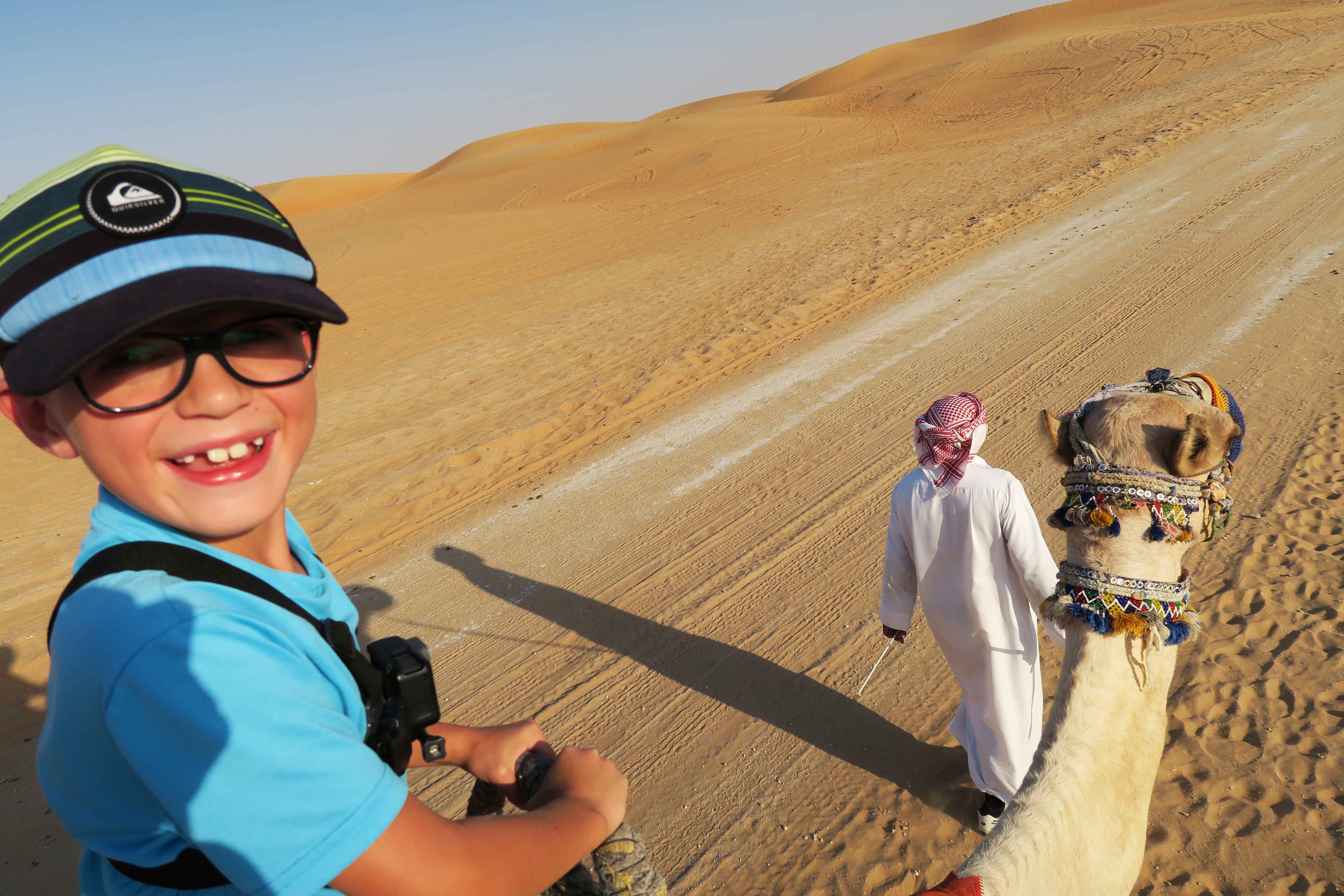 Going to Dubai or Abu Dhabi in the United Arab Emirates and looking for more info on which desert safari is best for families. Here is all the info you need to know about things to do on a Dubai desert safari with kids including: camel riding, sand dunes, sandboarding, evening safari, dune bashing, henna tattoos, belly dancing, camel farm and so much more . Easy, safe, and fun experiences for your next family holiday to UAE. #desertsafari #dubai #uae #abudhabi #camelriding #sandboarding