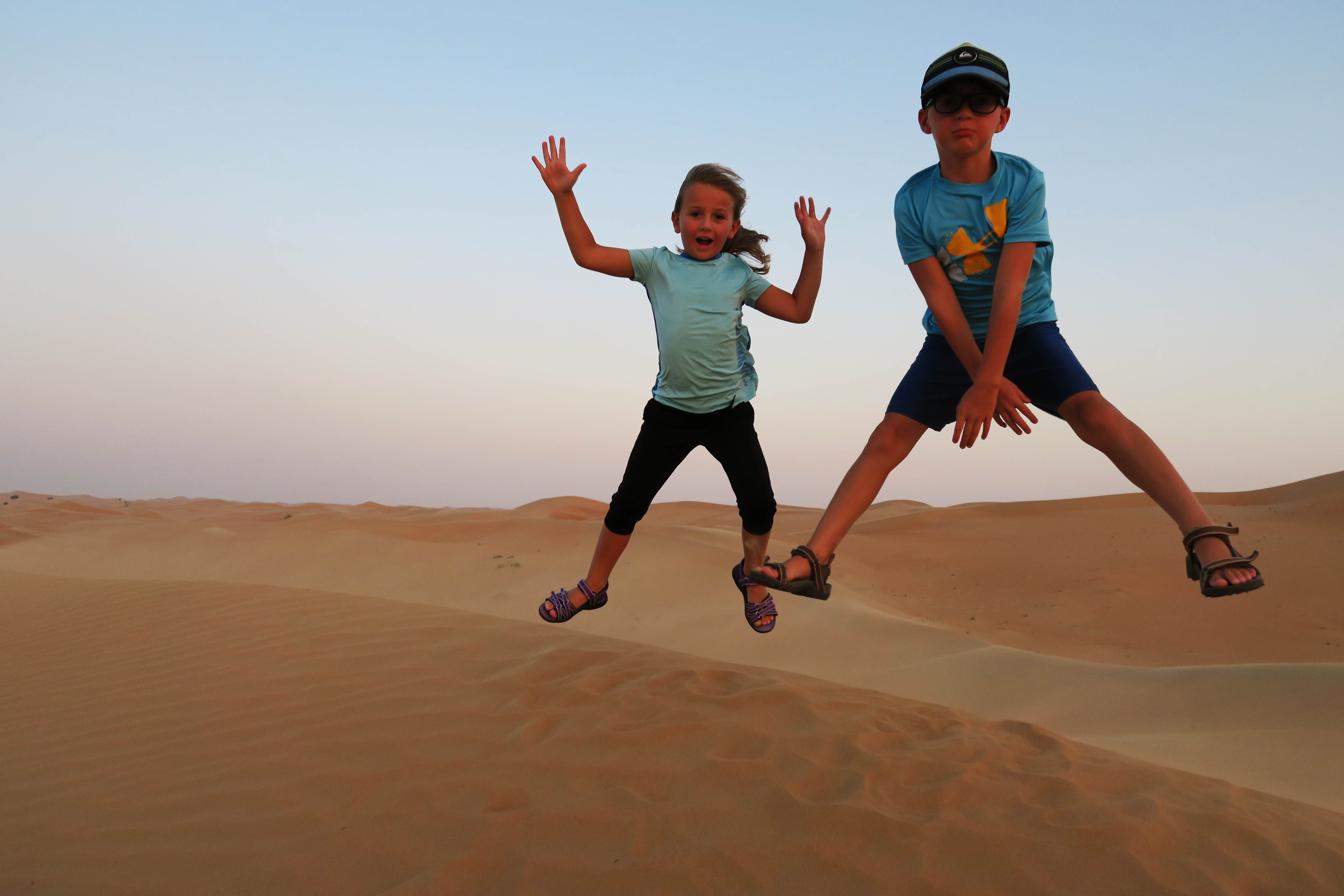 Going to Dubai or Abu Dhabi in the United Arab Emirates and looking for more info on which desert safari is best for families. Here is all the info you need to know about things to do on a Dubai desert safari with kids including: camel riding, sand dunes, sandboarding, evening safari, dune bashing, henna tattoos, belly dancing, camel farm and so much more . Easy, safe, and fun experiences for your next family holiday to UAE. #desertsafari #dubai #uae #abudhabi #camelriding #sandboarding